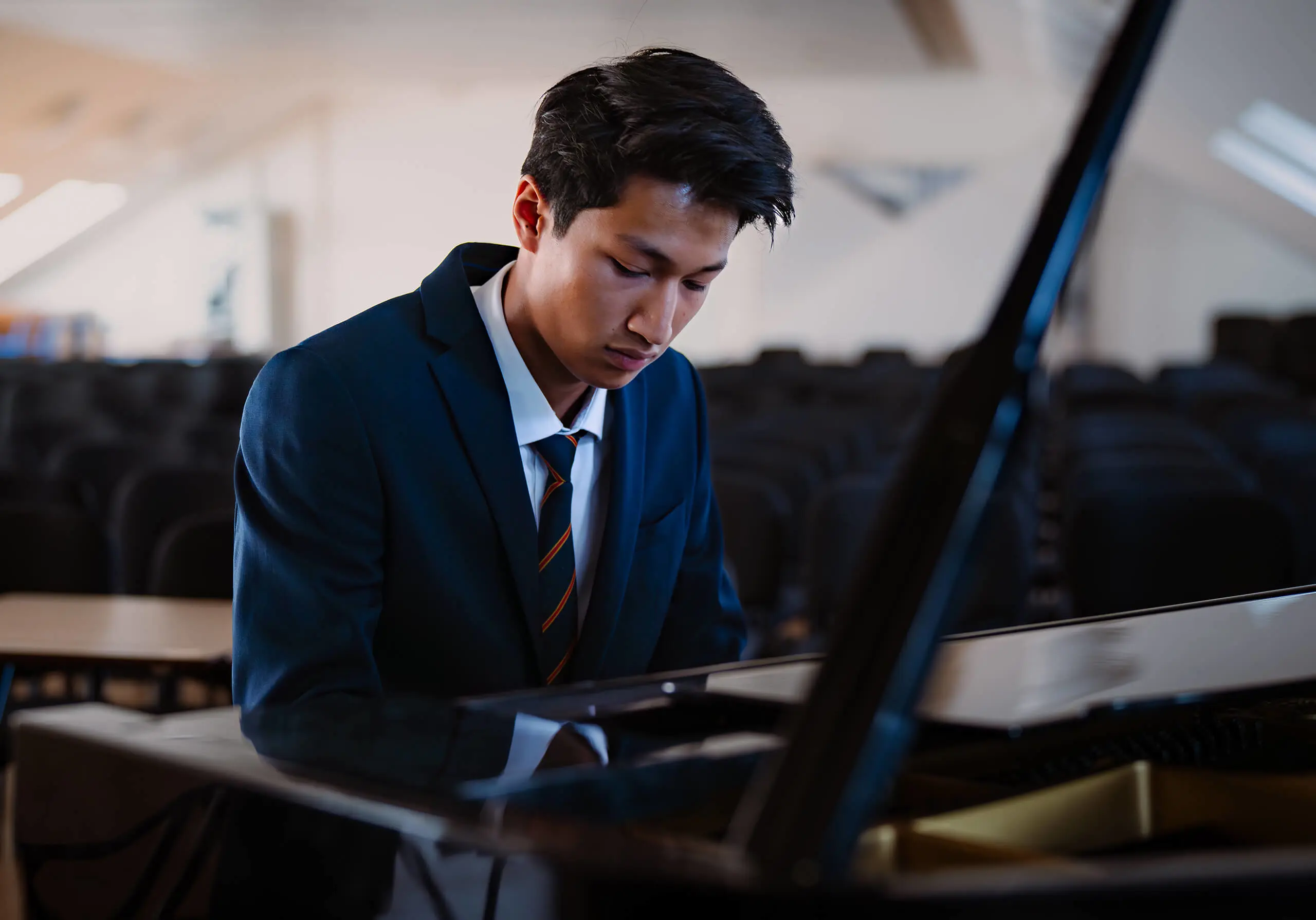 St George's Cologne COBIS banner - Senior pupil playing piano